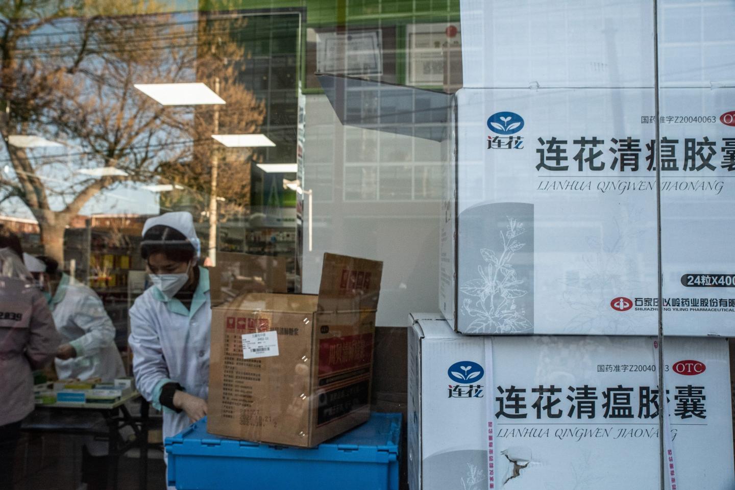 Chinese workers sort boxes of Chinese medicine