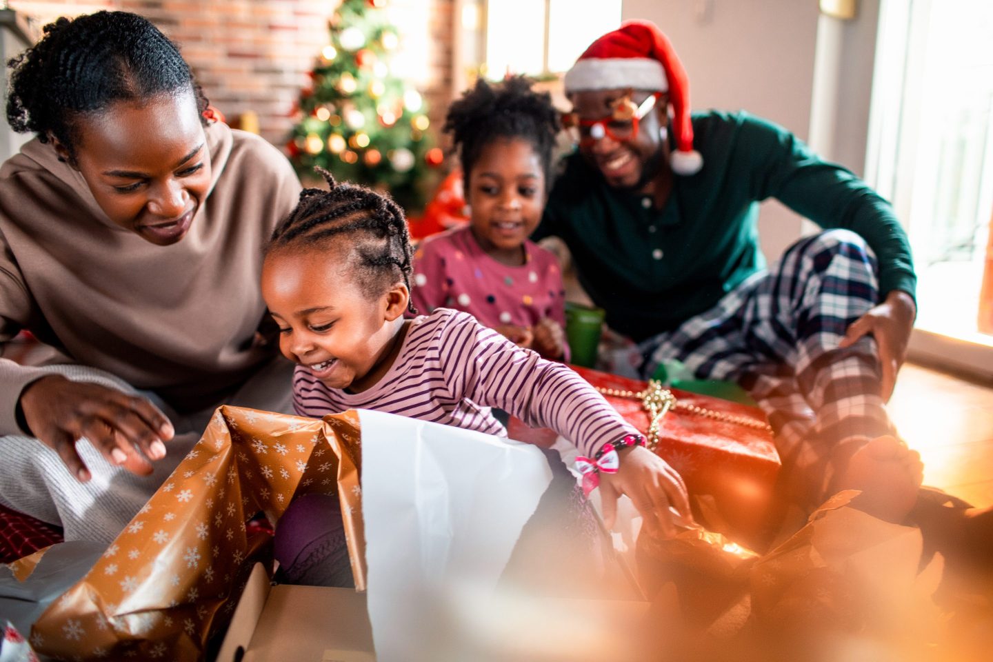 Close up of a young family opening their presents on Christmas morning