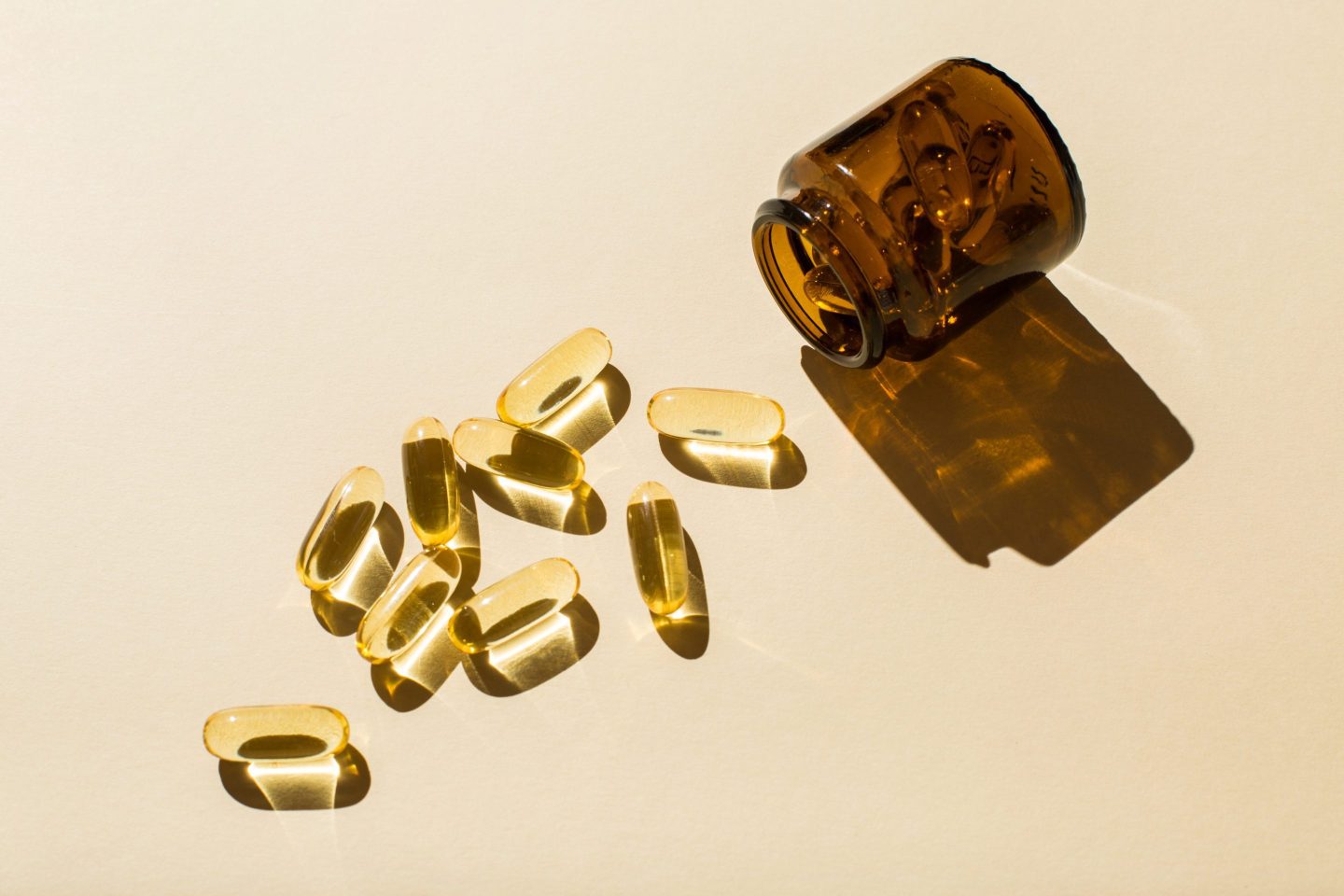 Omega 3 fish oil capsules and a glass bottle.
