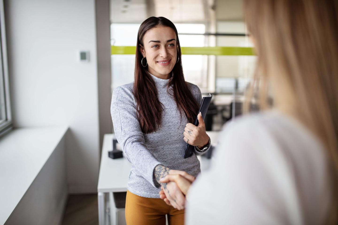 woman shakes hands for job interview