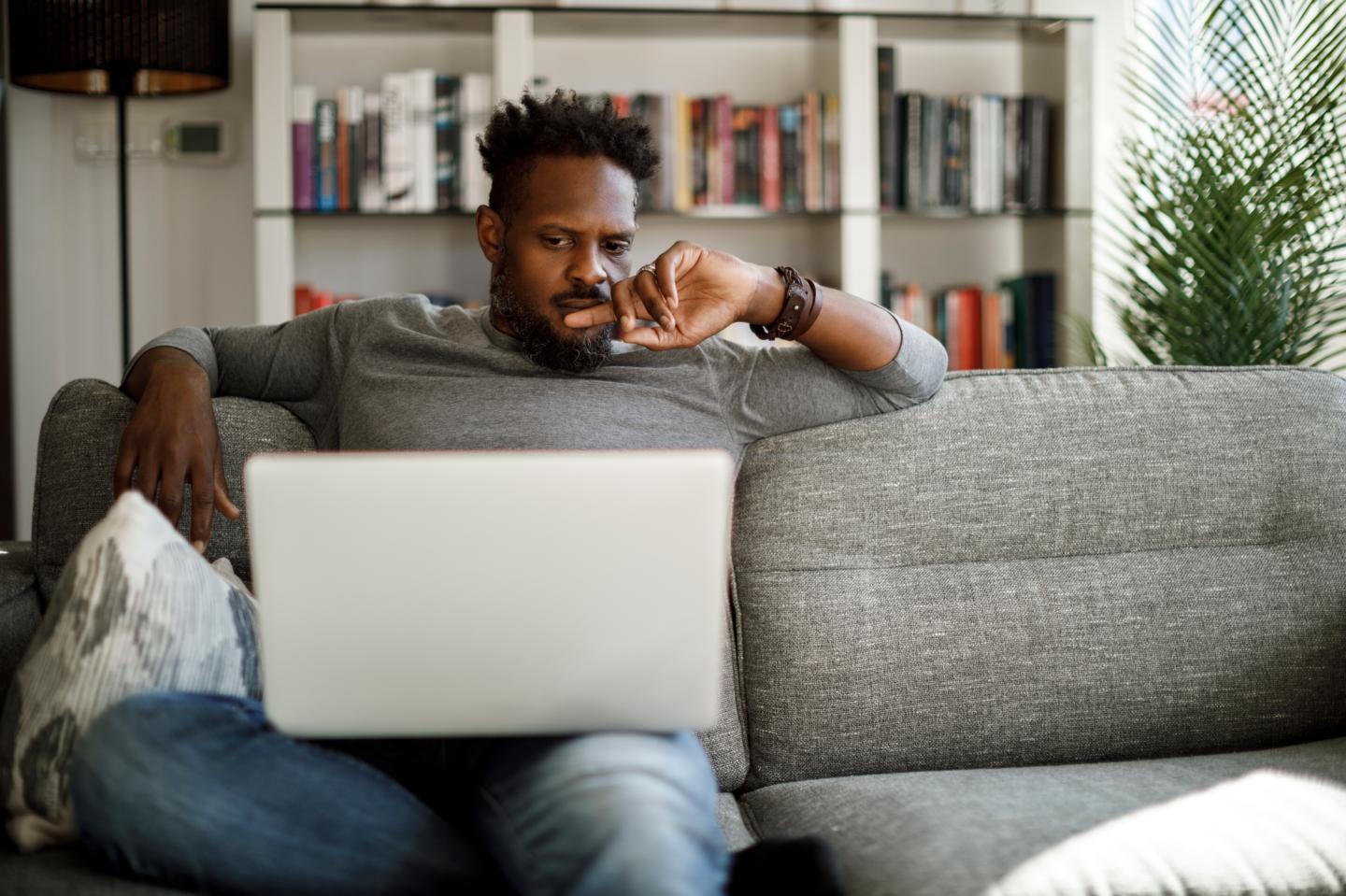 A young man looking at a computer.