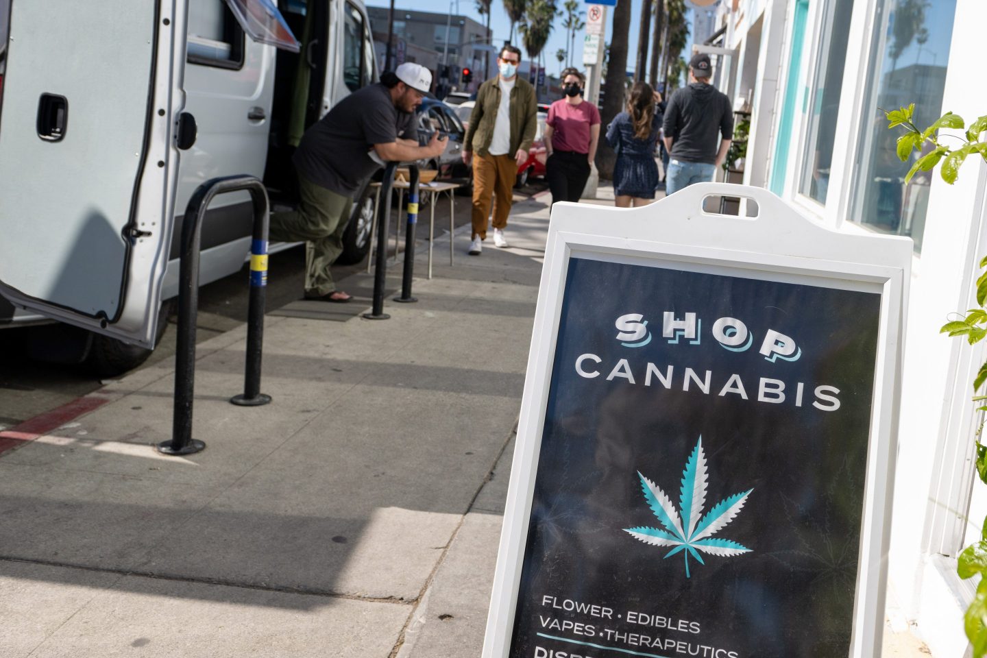 A "shop cannabis" sign is displayed on the street