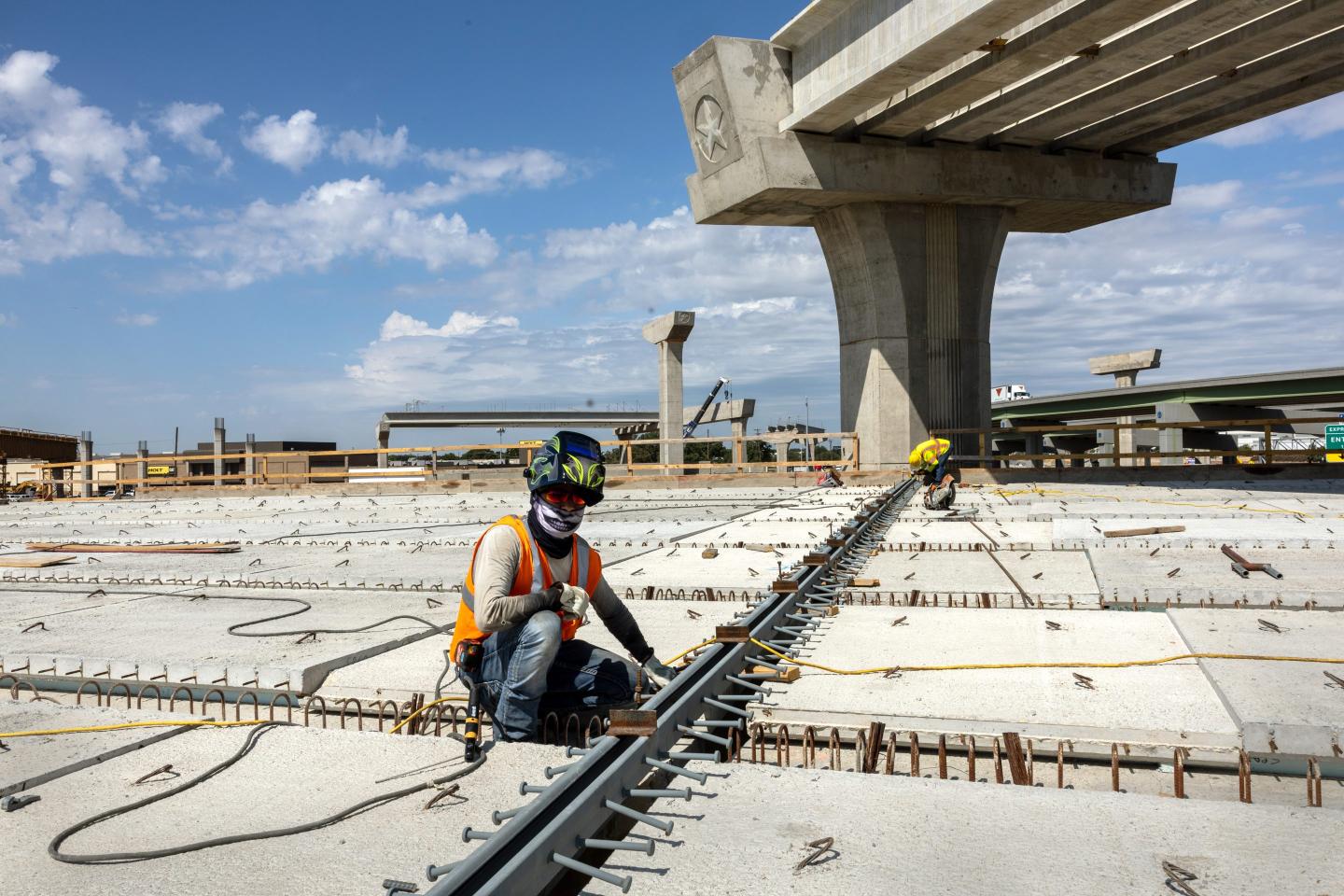 A welder works on an overpass on the Irving Interchange infrastructure project at the site of the former Dallas Cowboys Stadium on August 10, 2022 in Irving, Texas.