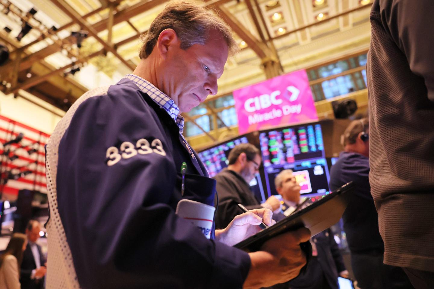 Traders work on the floor of the New York Stock Exchange during morning trading on December 02, 2022.