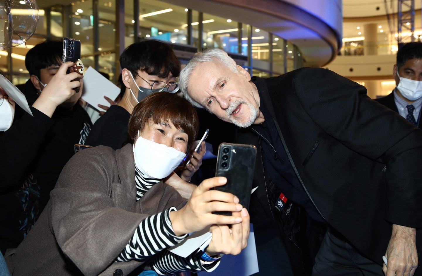 Director James Cameron poses for photos with fans