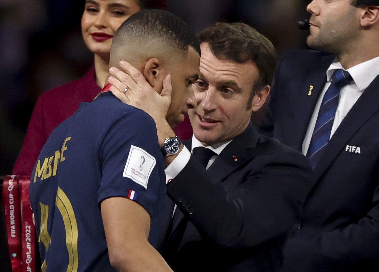 Kylian Mbappe of France is consoled by President of France Emmanuel Macron