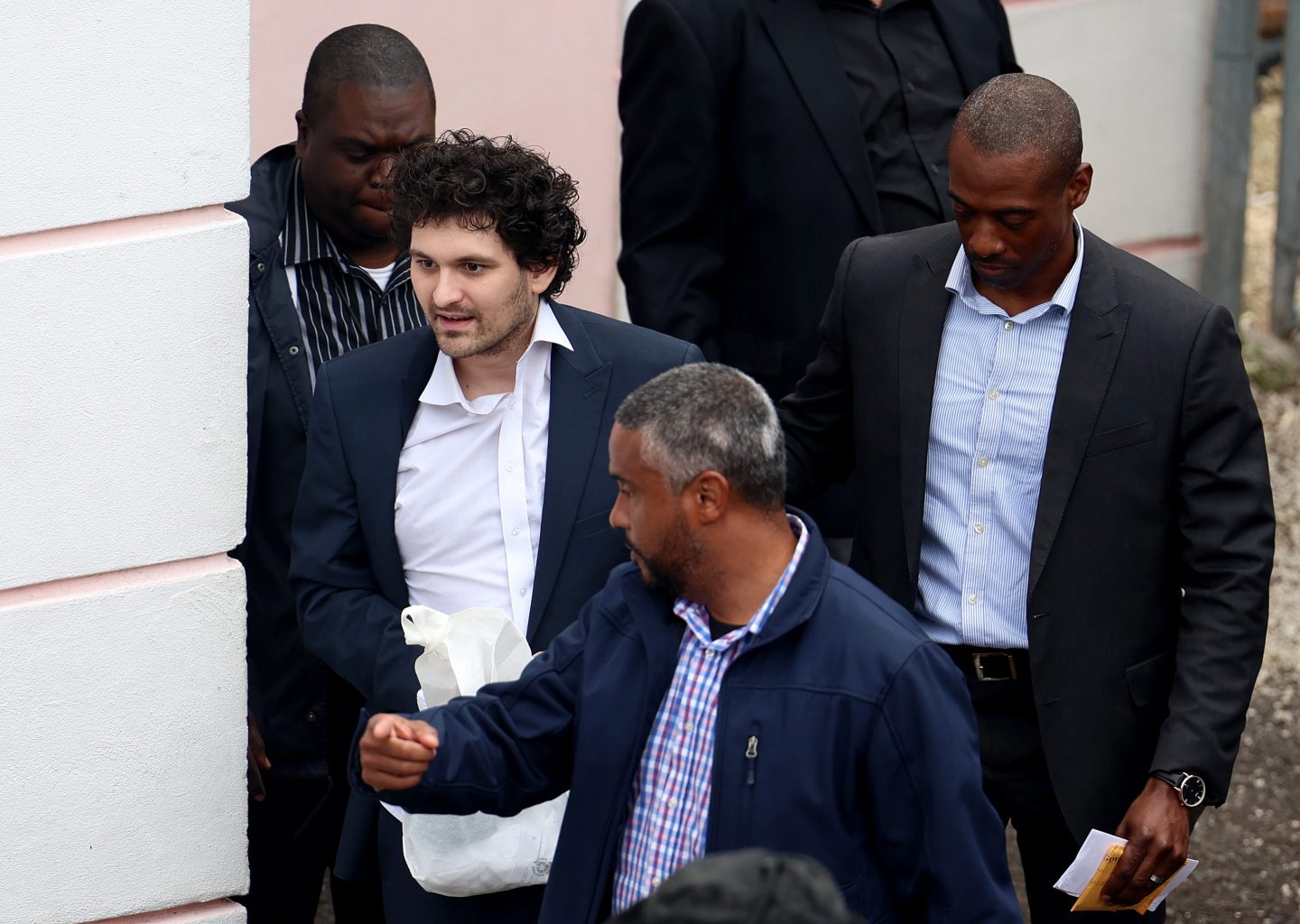 Sam Bankman-Fried with authorities in the Bahamas.