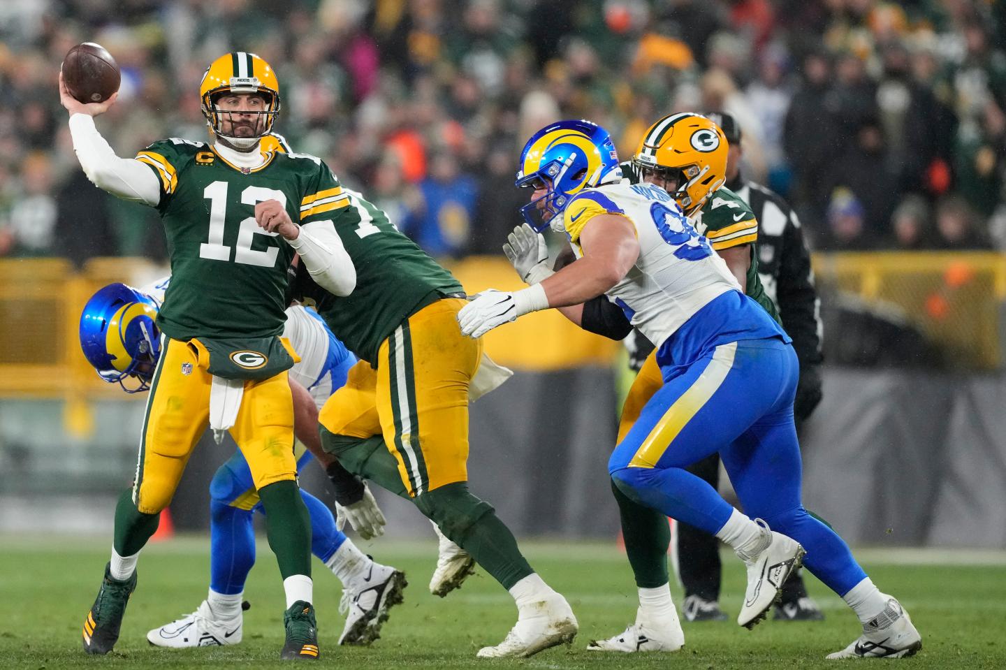 Aaron Rodgers throwing a football during an NFL game.