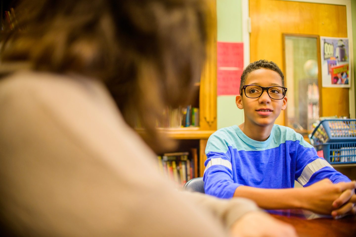 Teenage boy at school speaking to guidance counselor