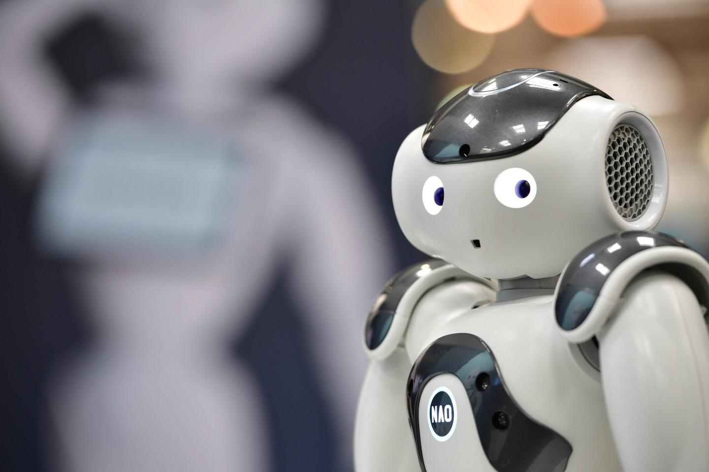 NAO, a humanoid robot, entertains visitors at the SoftBank Robotics stand at the 2018 CeBIT technology trade fair on June 12, 2018 in Hanover, Germany.