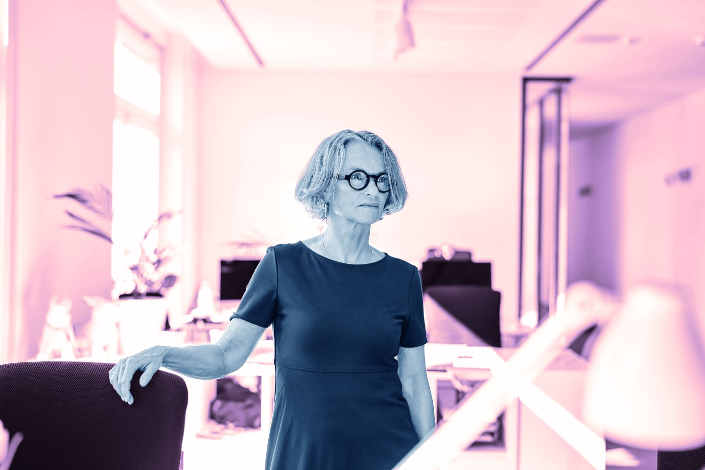 Mature businesswoman looking away while standing in office