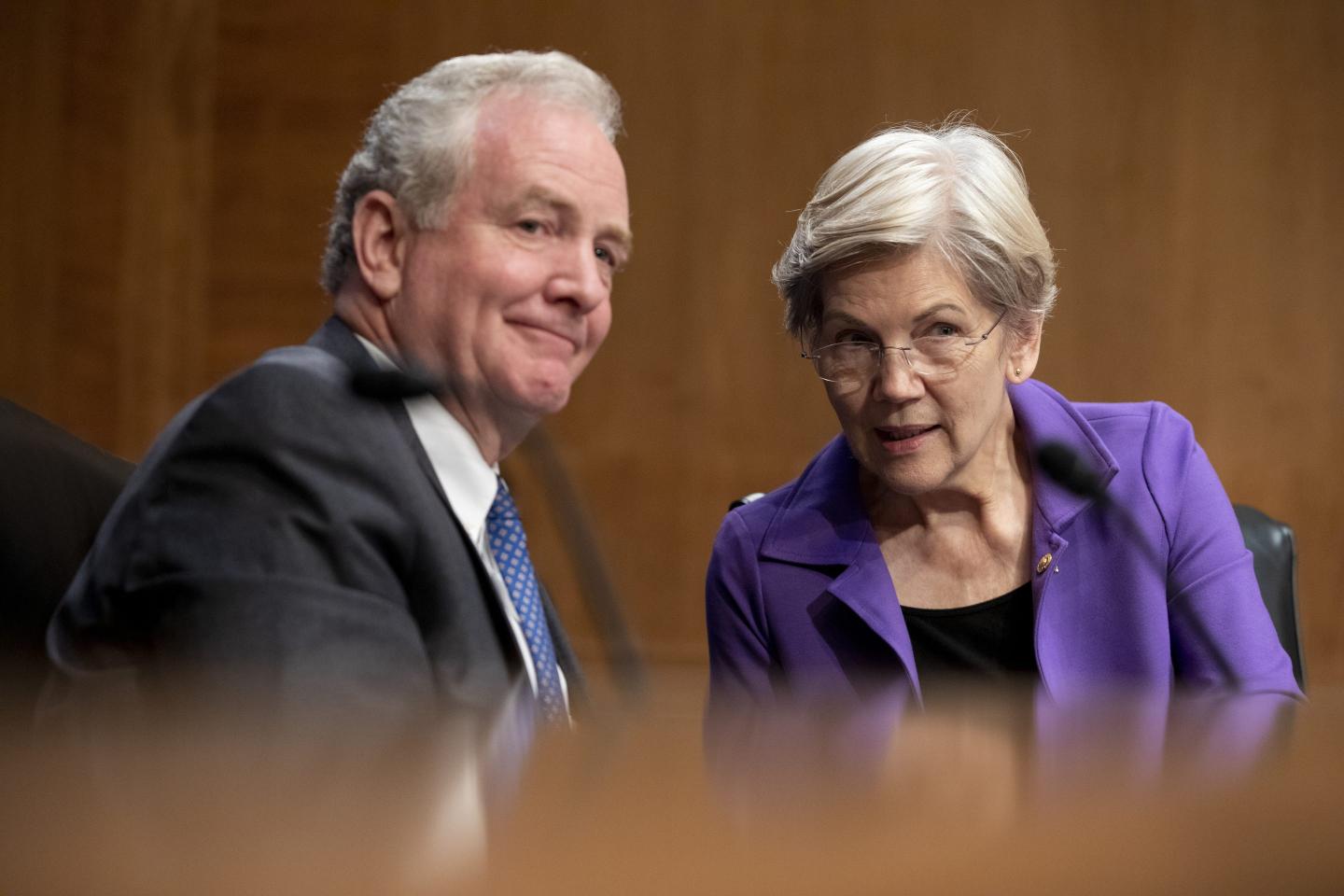 Sen. Chris Van Hollen (D-Md.) and Sen. Elizabeth Warren (D-Mass.) speak during a Senate Banking, Housing, and Urban Affairs Committee nomination hearing on Nov. 30
