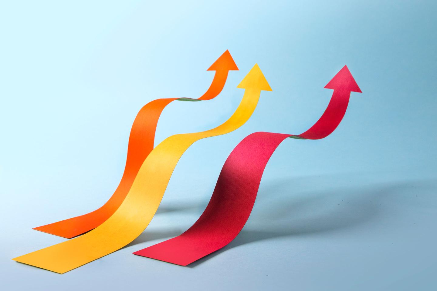 Abstract financial growth coloured bar with arrow head moving upwrads still life.