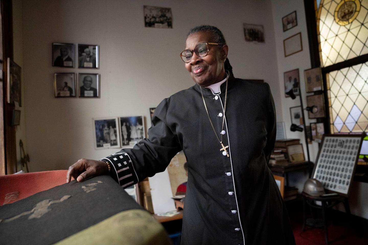 Rev. Monica Marshall browses a room containing artifacts of the church's history.