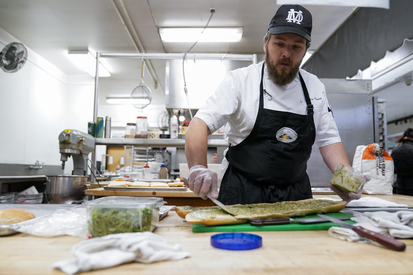 Chef Josh Gjersand prepares a sandwich for Mount Diablo High School students to try during a taste test