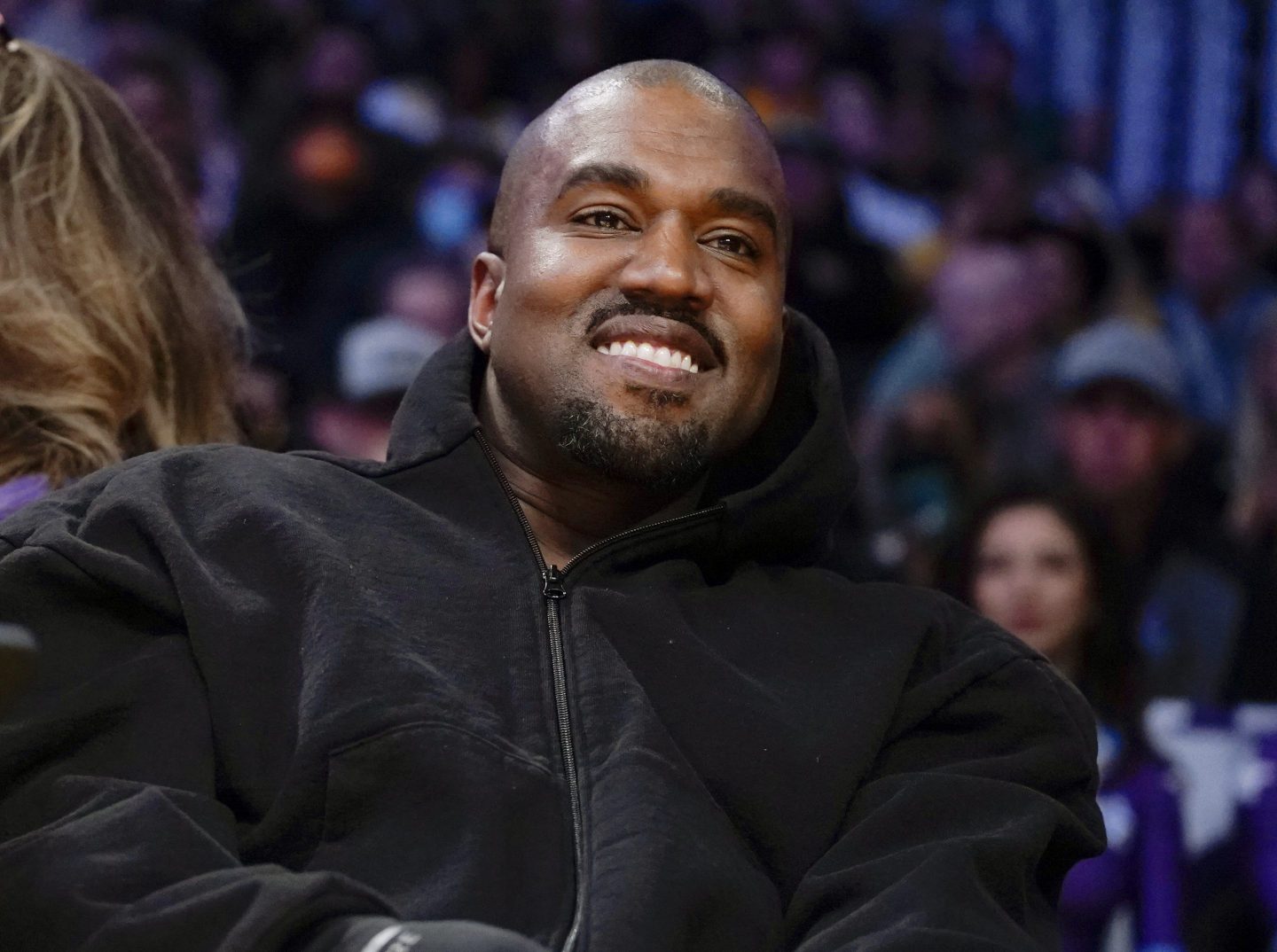 Kanye West, known as Ye, watches the first half of an NBA basketball game between the Washington Wizards and the Los Angeles Lakers in Los Angeles, on March 11, 2022.