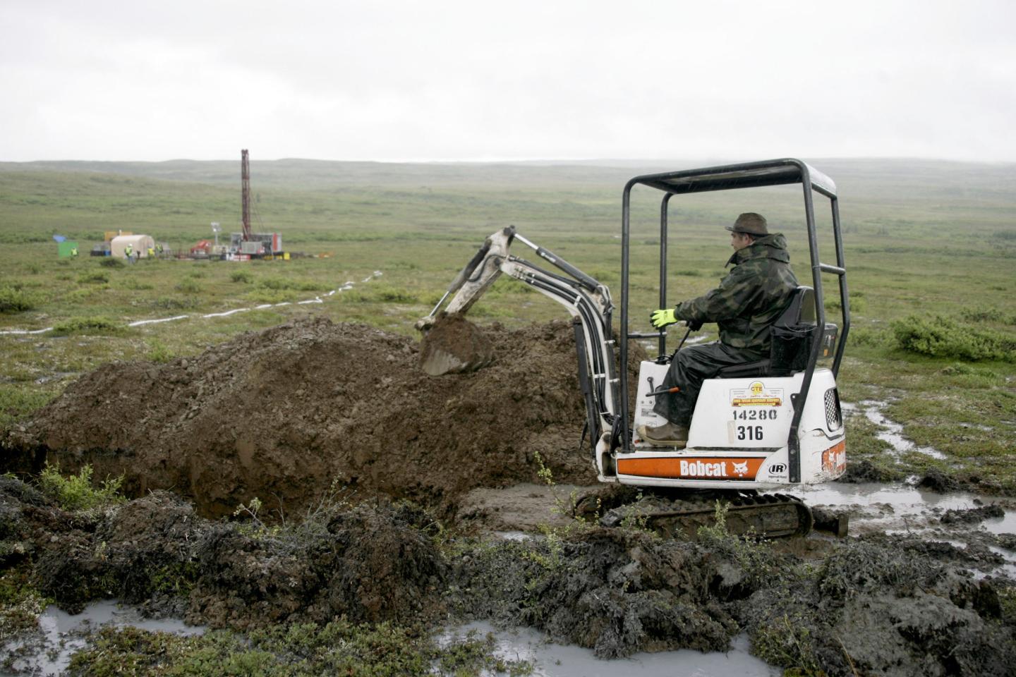 A worker with the Pebble Mine project digs in the Bristol Bay region of Alaska near the village of Iliamma, Alaska, July 13, 2007.