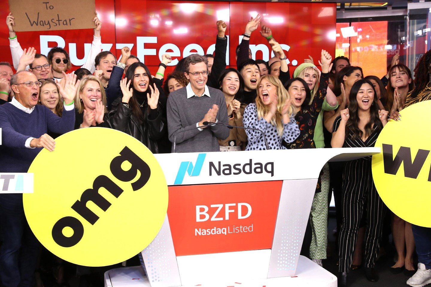 Founder and CEO of BuzzFeed Jonah H. Peretti (C) celebrates with team members as he rings the bell during BuzzFeed Inc.'s Listing Day at Nasdaq in December 2021.