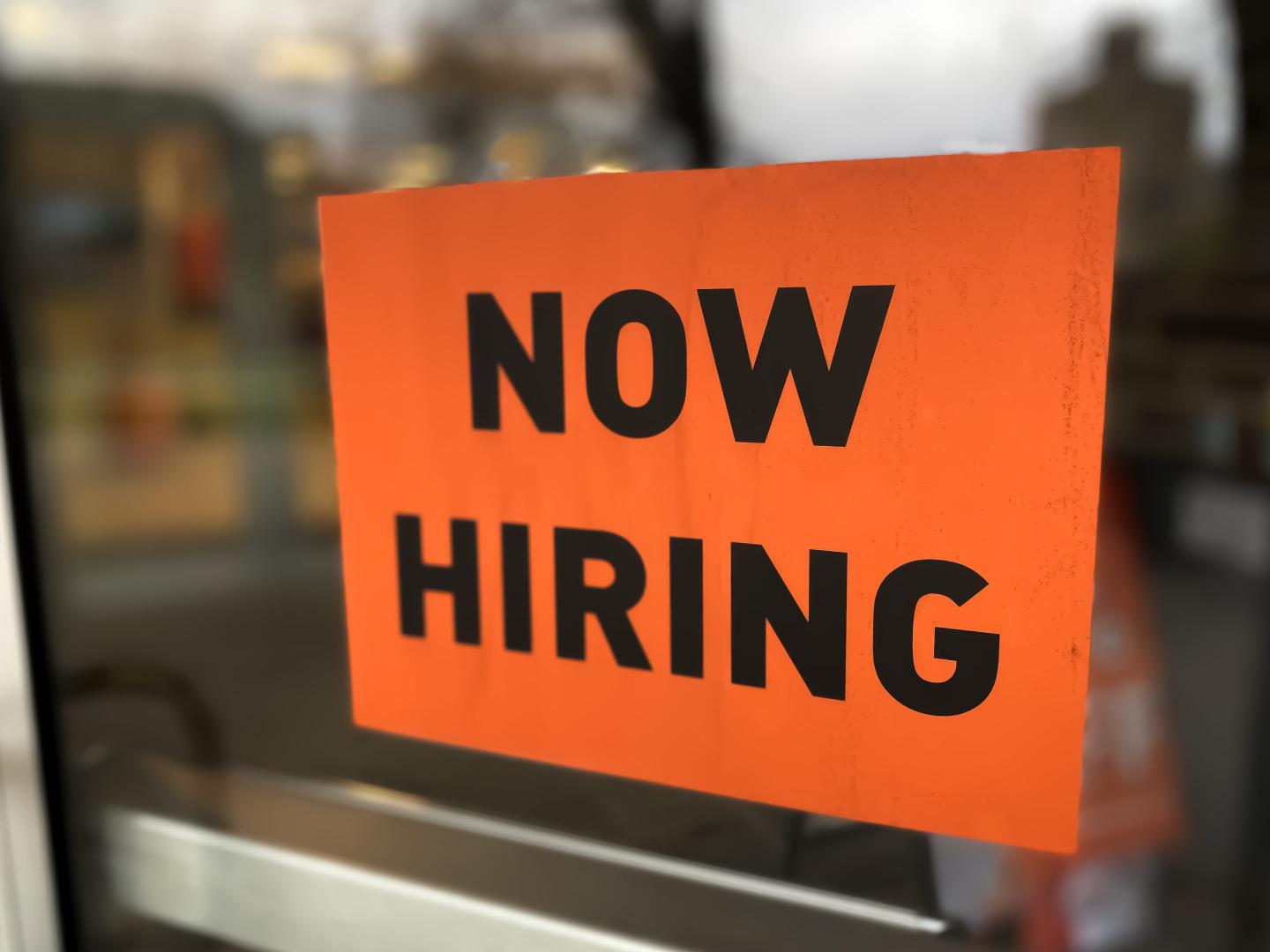 “now hiring” sign