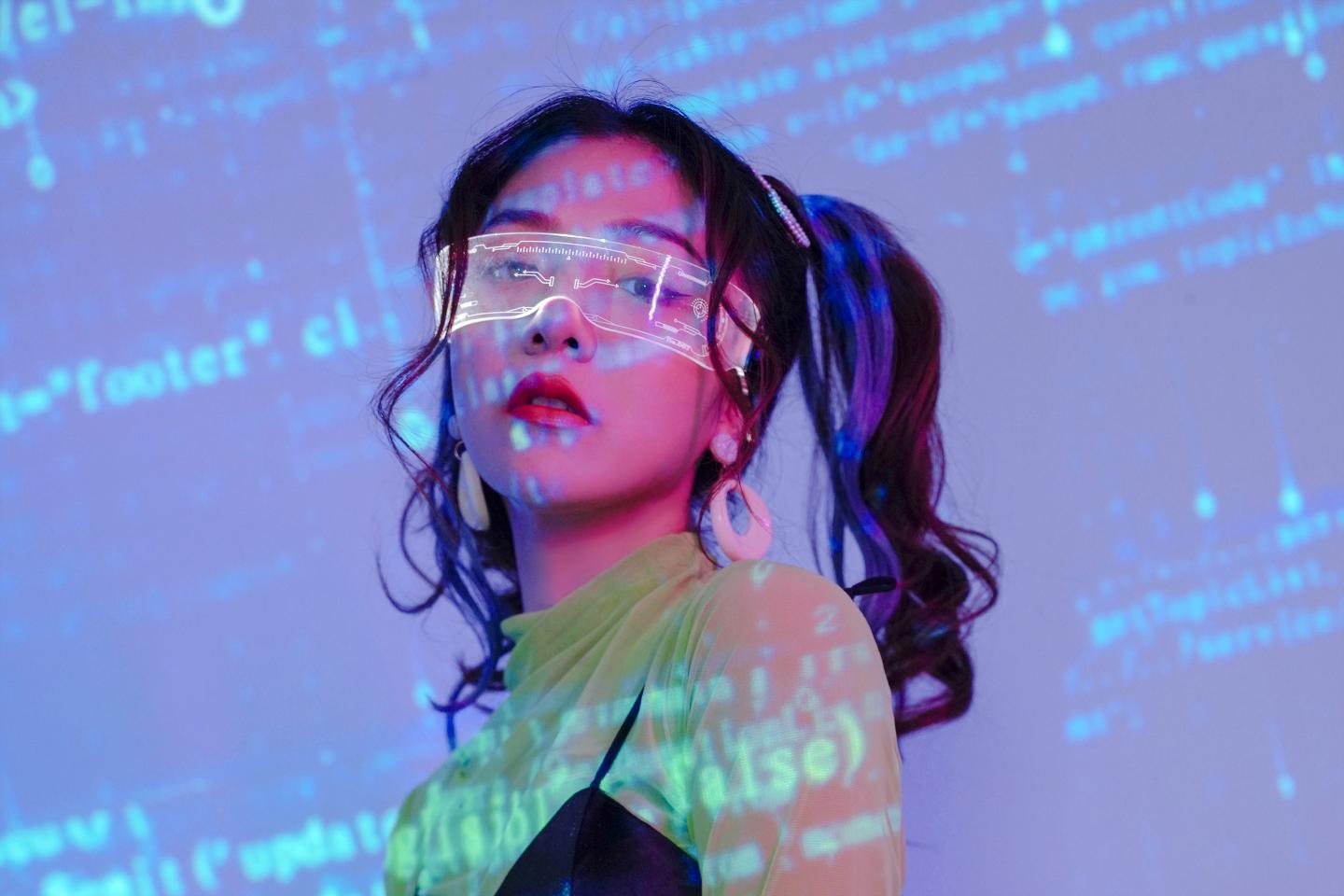 Portrait of Dovey Wan against a background with code.