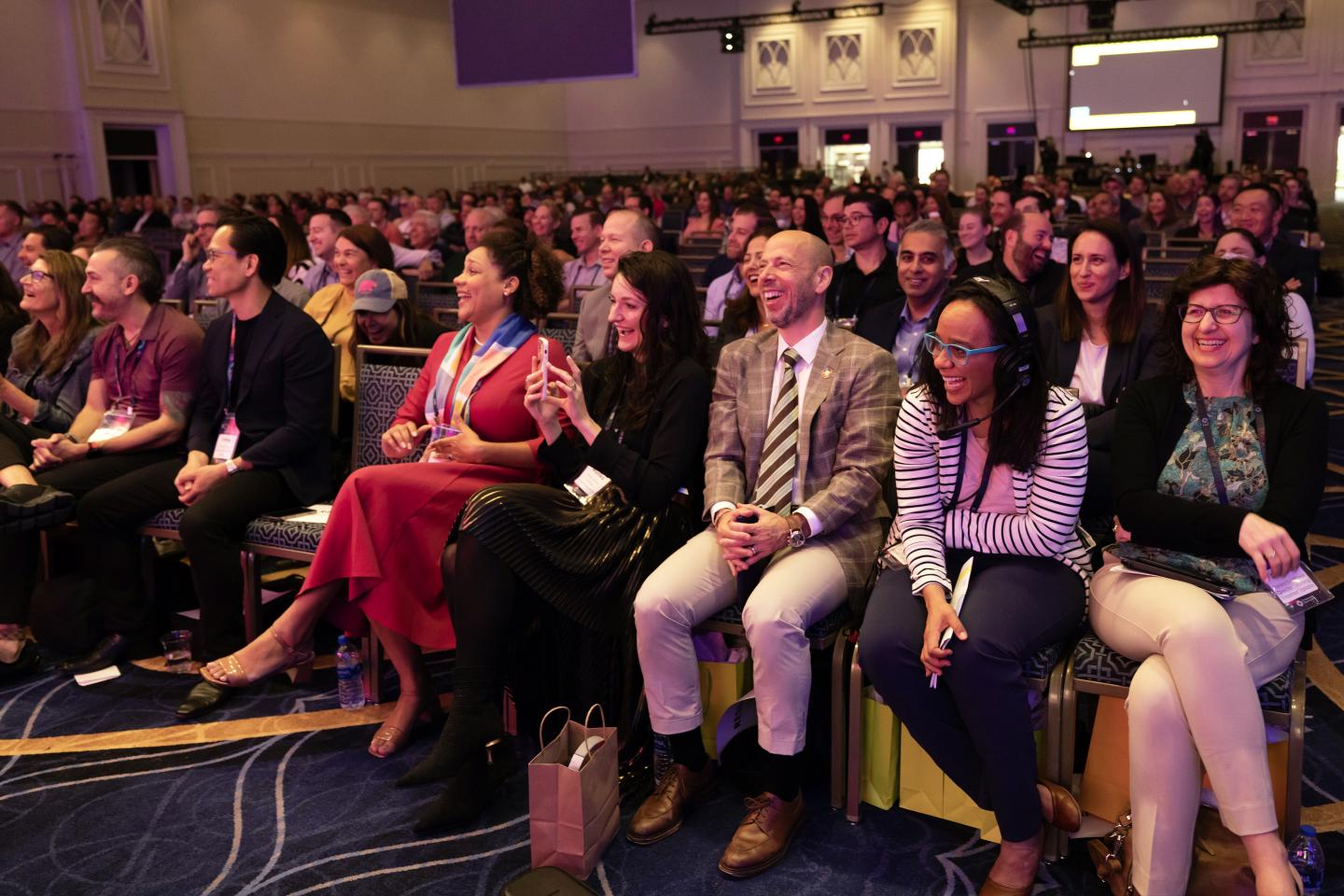 Photo of an audience laughing during a presentation for startup founders