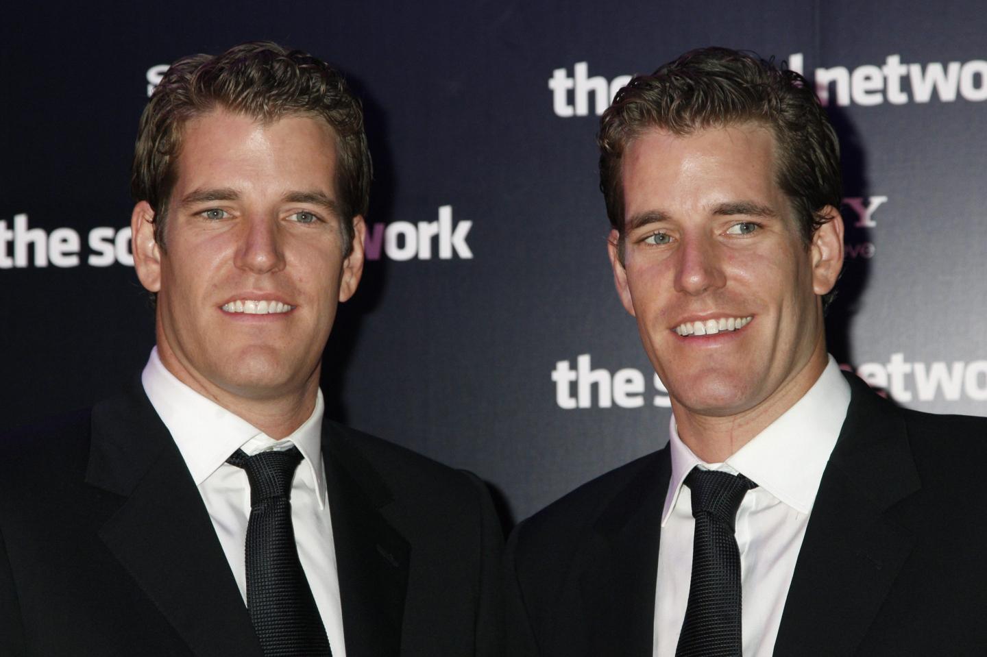Entrepreneurs Tyler and Cameron Winklevoss pose prior to attend the Premiere of the film "The social network" directed by David Fincher on October 3, 2010 in Paris
