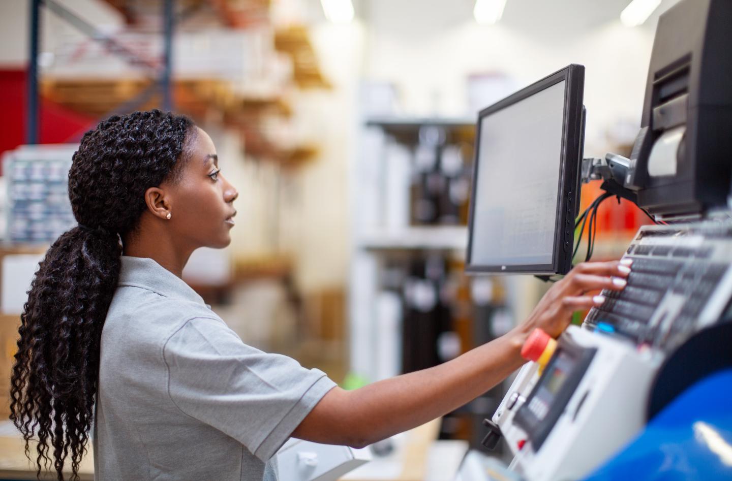 A woman operating a machine.