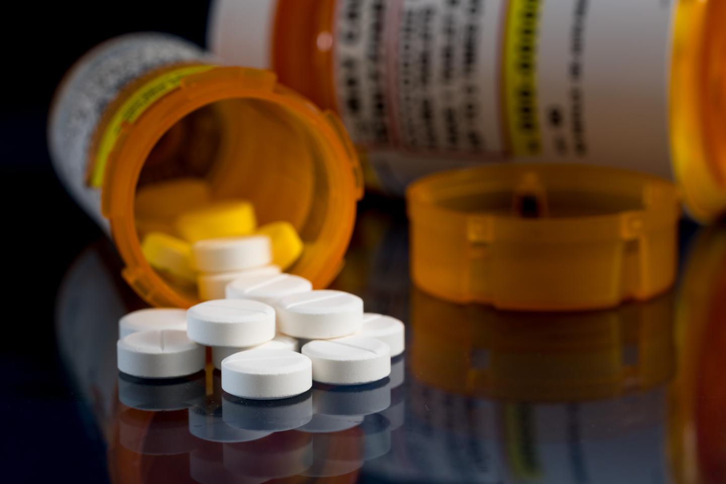 Pills spilling out of a bottle.
