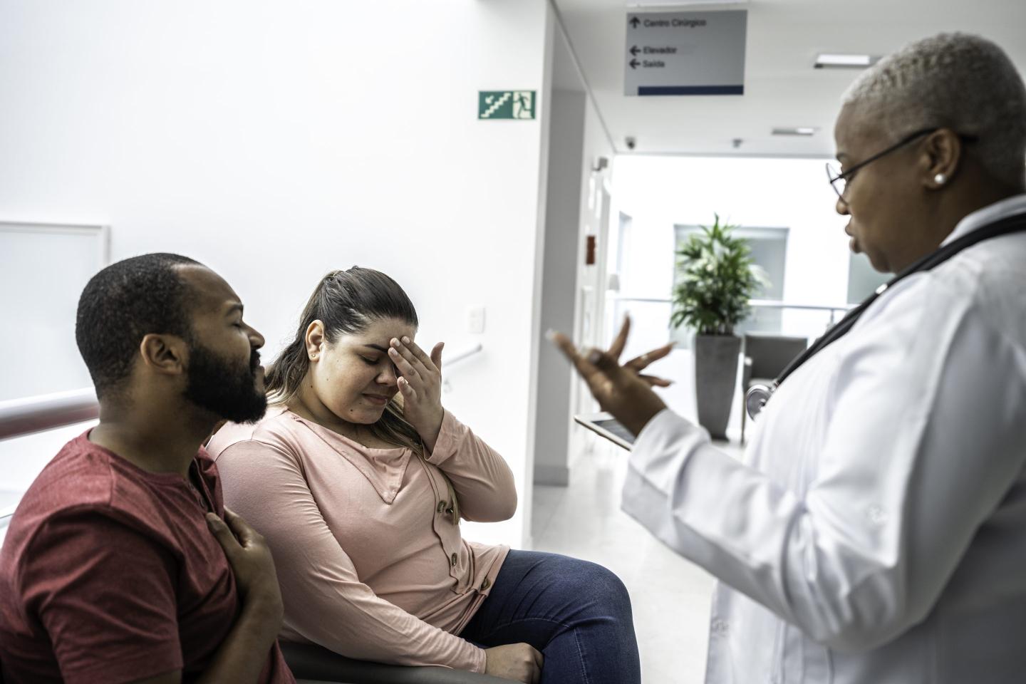 Female doctor talking about medical test to her patients at hospital