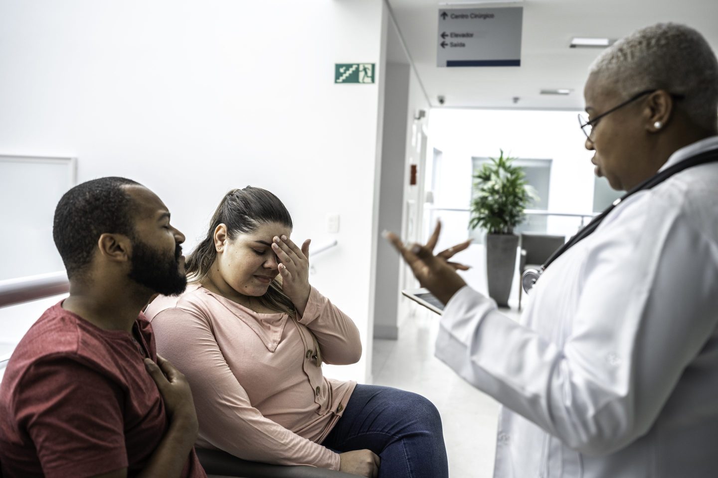 Female doctor talking about medical test to her patients at hospital