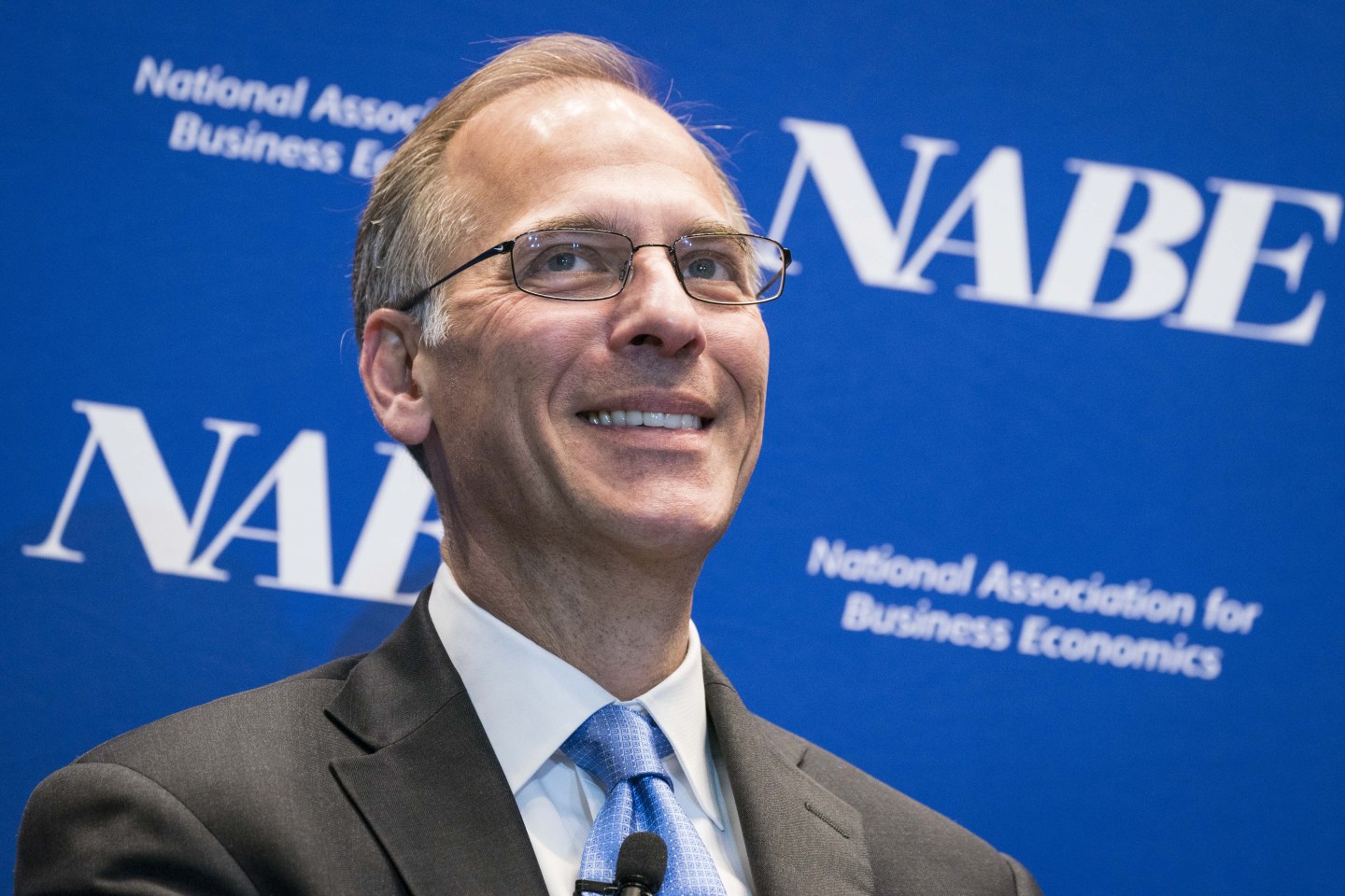 Mark Zandi, chief economist at Moody's, smiling during a panel presentation