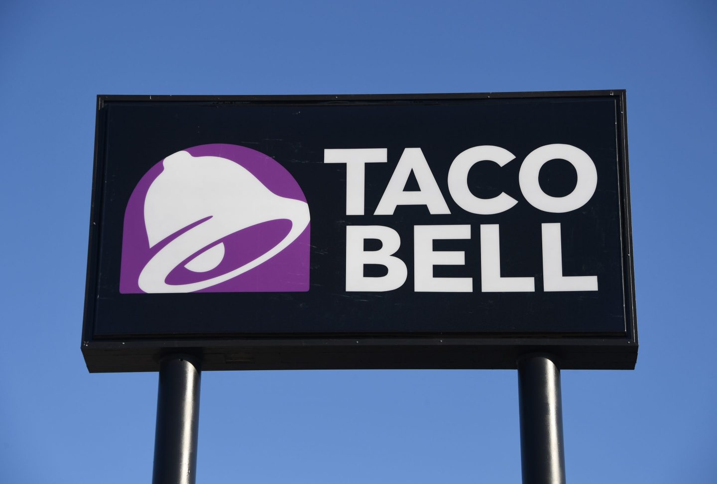 An exterior view shows a sign at a Taco Bell restaurant