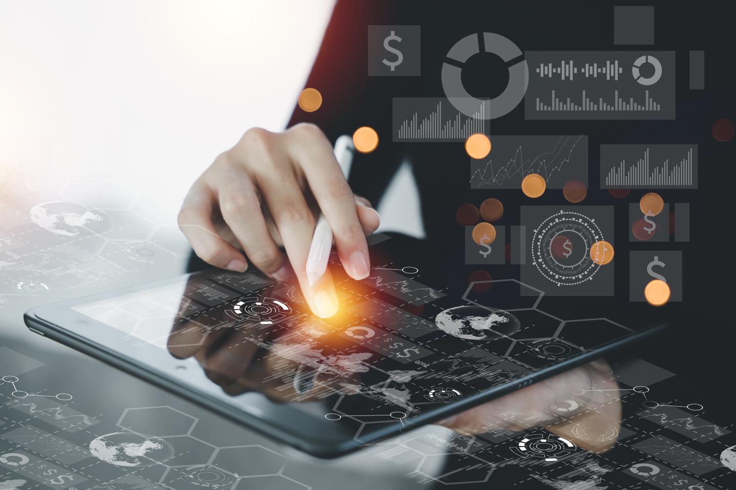 businesswoman working with laptop computer and digital tablet and smart phone on desk in modern office with virtual icons interface.