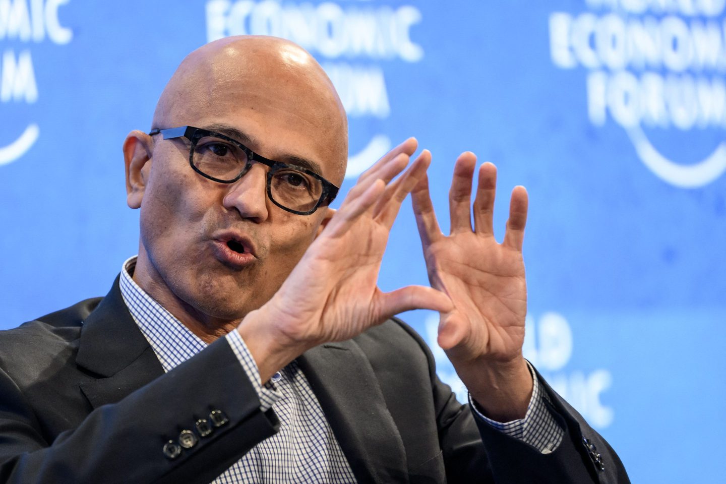 Microsoft CEO Satya Nadella has been touting artificial intelligence at Davos this week, while many of his employees face layoffs.