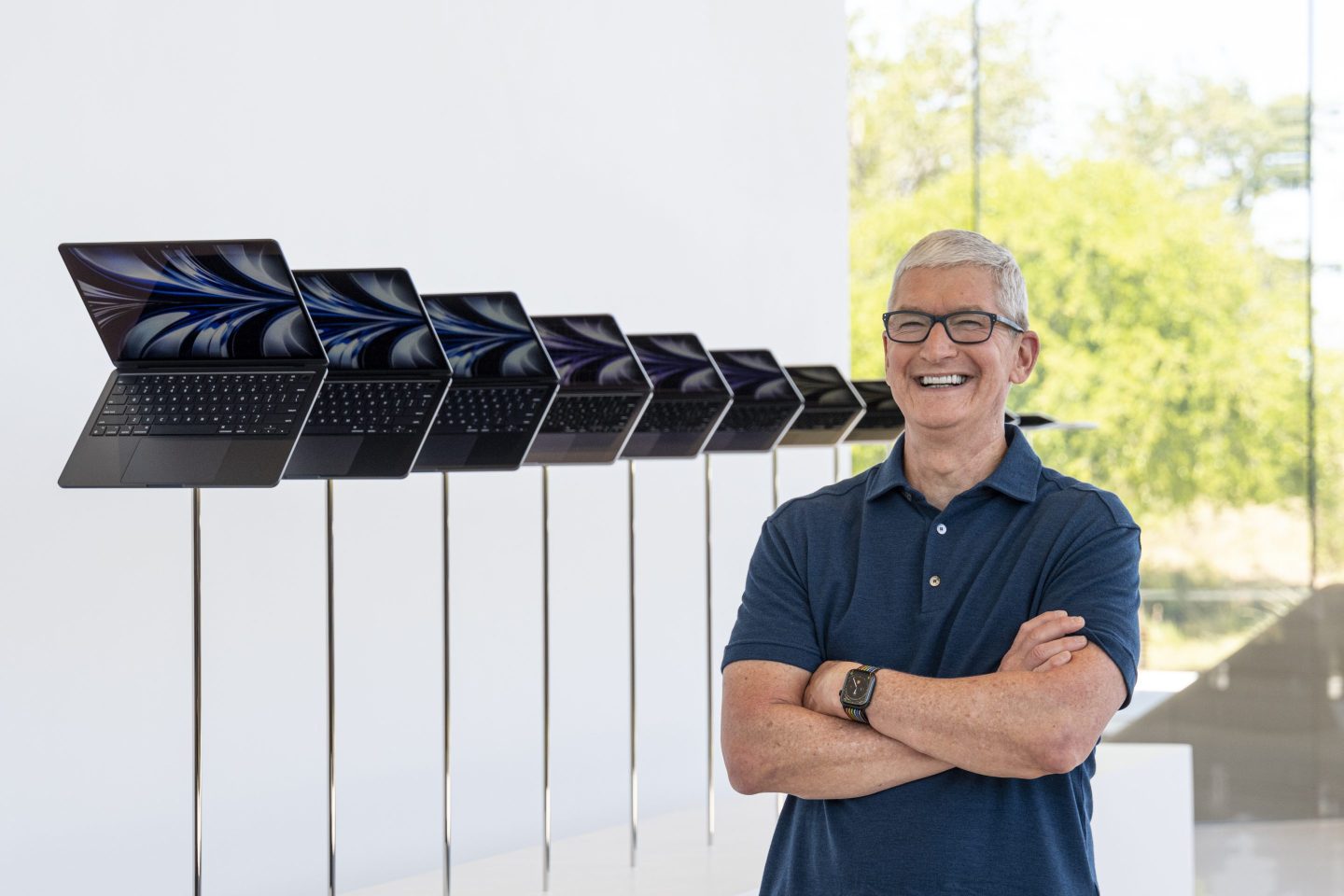 Tim Cook, chief executive officer of Apple Inc., next to a display of the new MacBook Air laptop computer during the Apple Worldwide Developers Conference at Apple Park campus in Cupertino, California, US, on Monday, June 6, 2022.