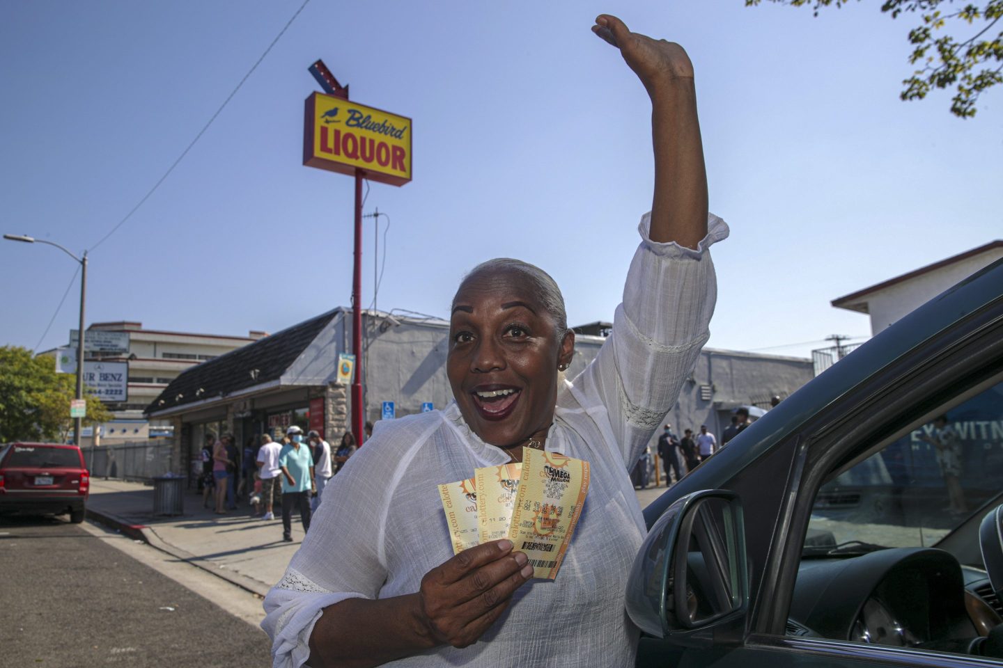 woman holds mega millions tickets