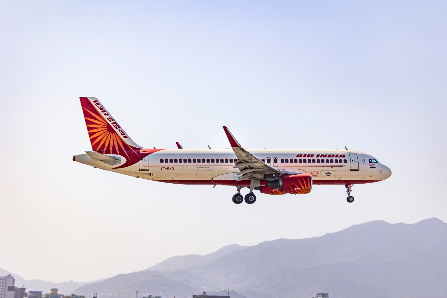 An Air India Airbus A320-200 passenger plane seen flying over the mountains of Kathmandu valley as it prepares to land in Tribhuvan International Airport KTM.