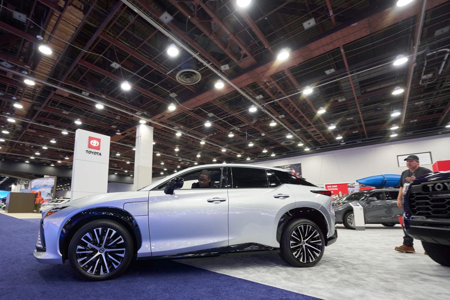 The Lexus RZ 450e is moved into position at the Toyota display