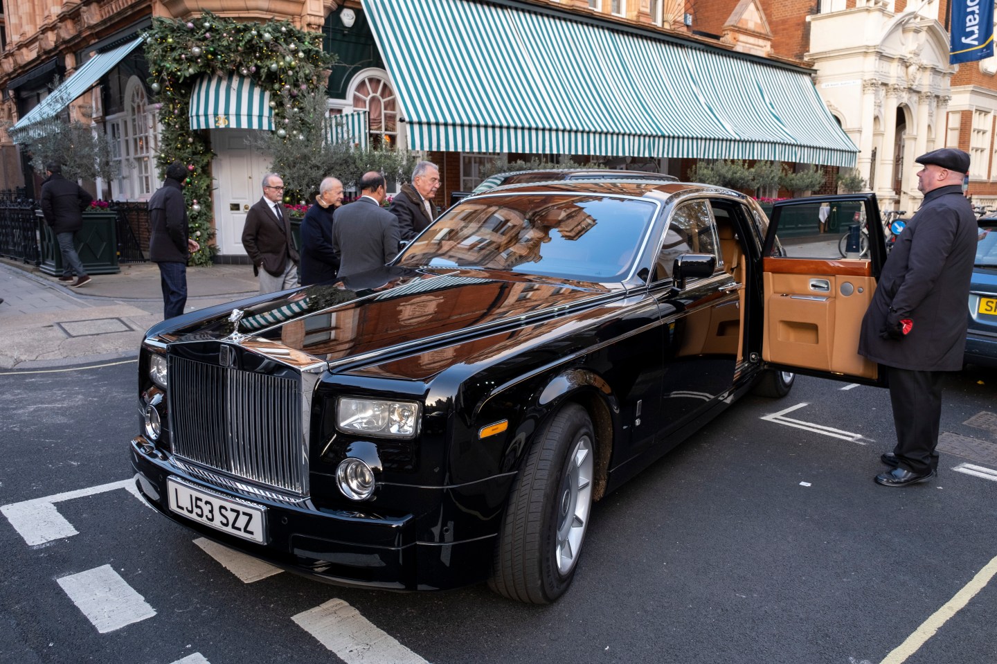 A Rolls Royce car on the street.