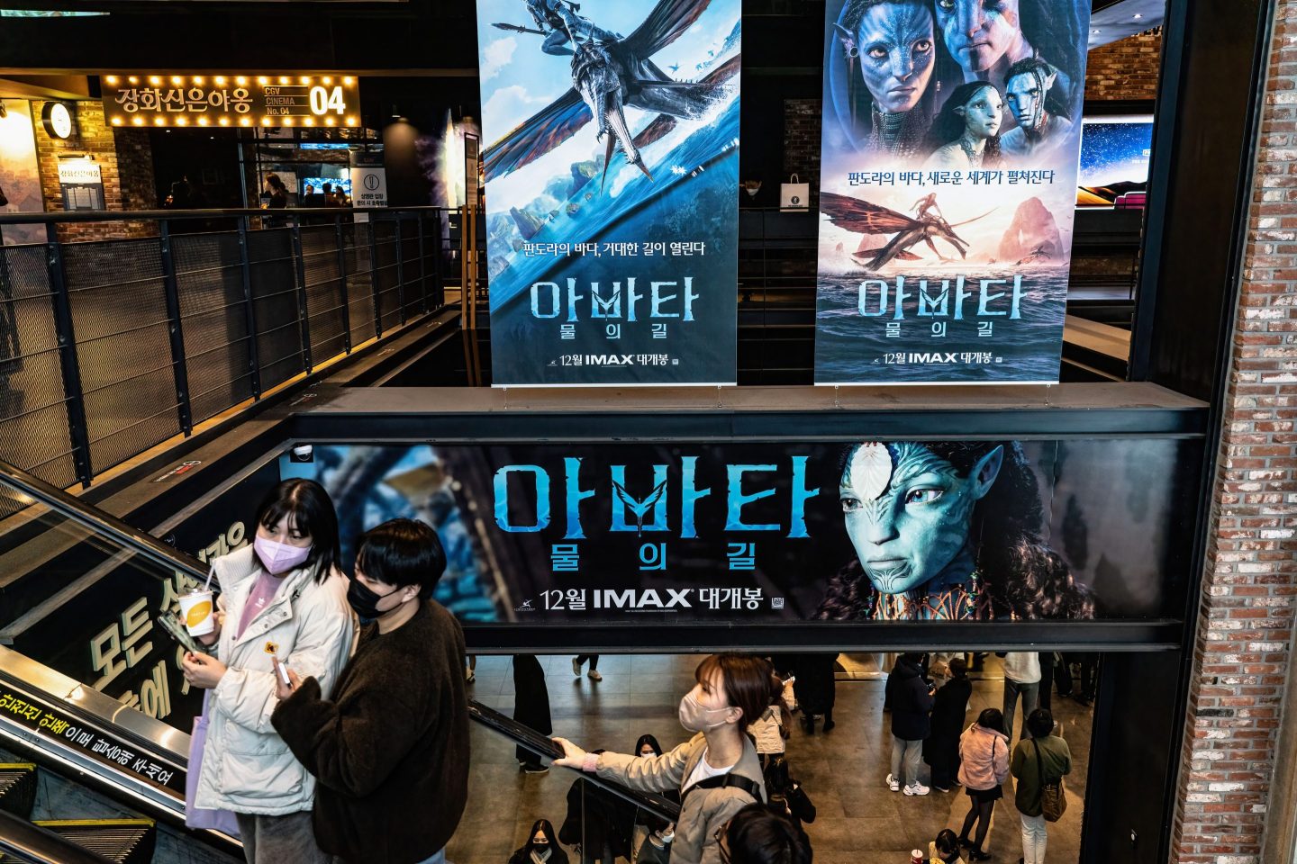"Avatar: The Way of Water" signboards are displayed at a movie theater in Seoul in December.