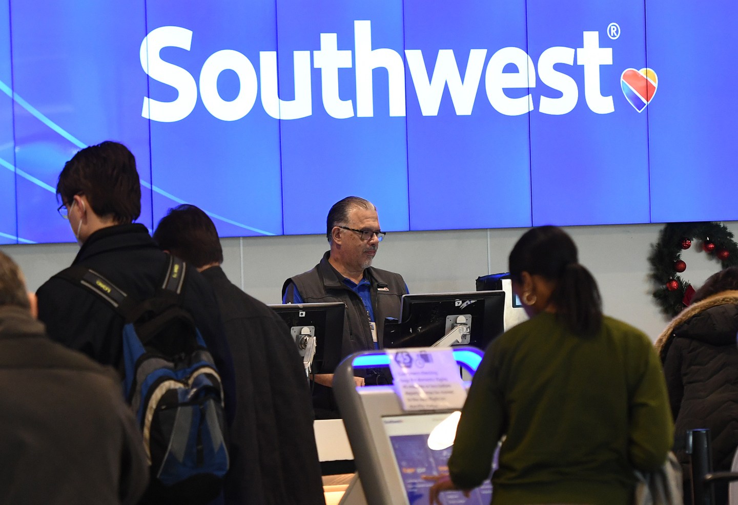 Travelers check in at a Southwest Airlines ticket counter