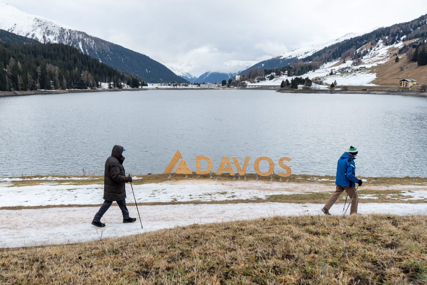 Walkers on a trail of thinning snow around Lake Davos in Davos, Switzerland, on Jan. 8, 2023.