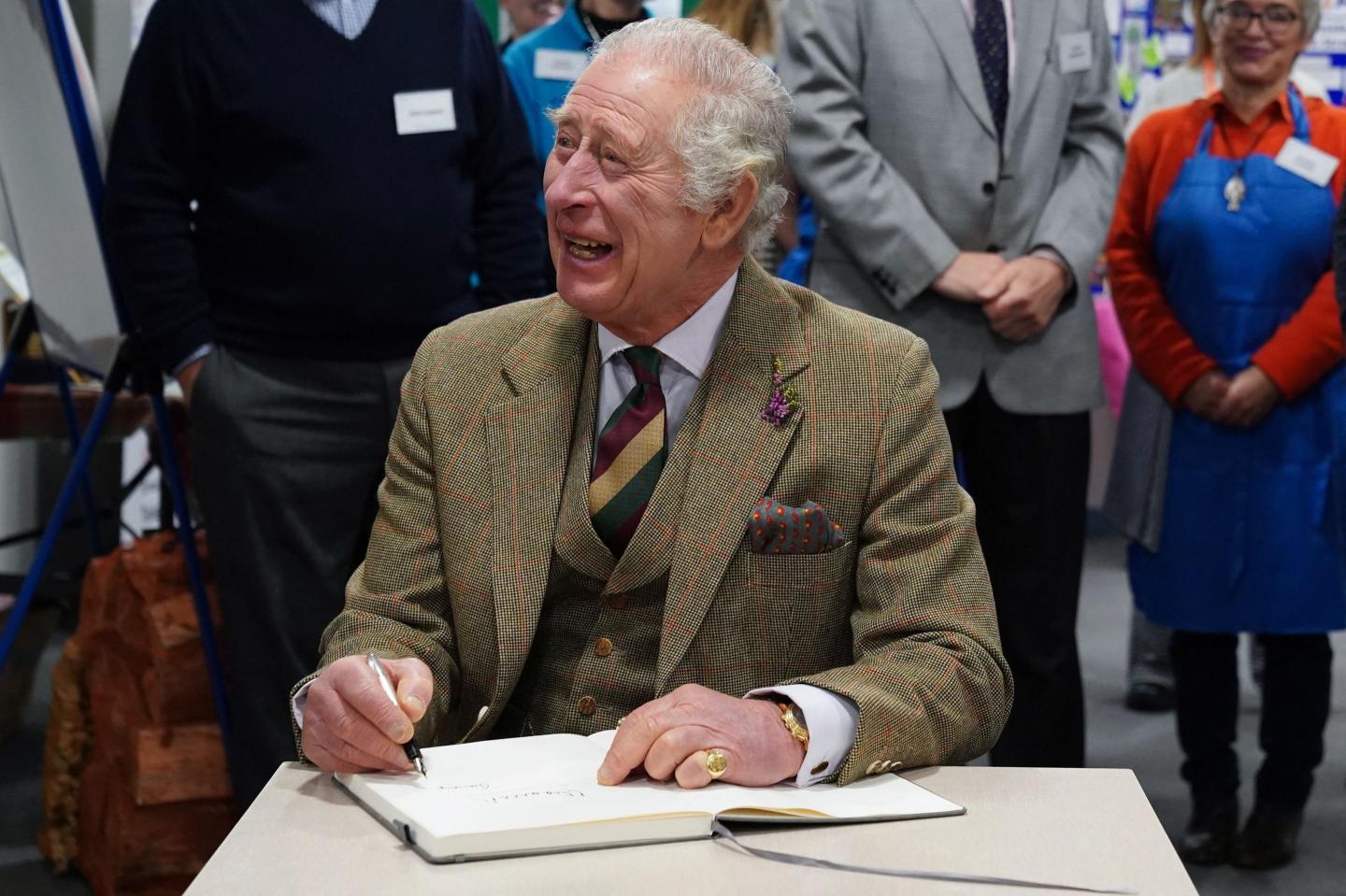 Britain's King Charles III signs a guestbook
