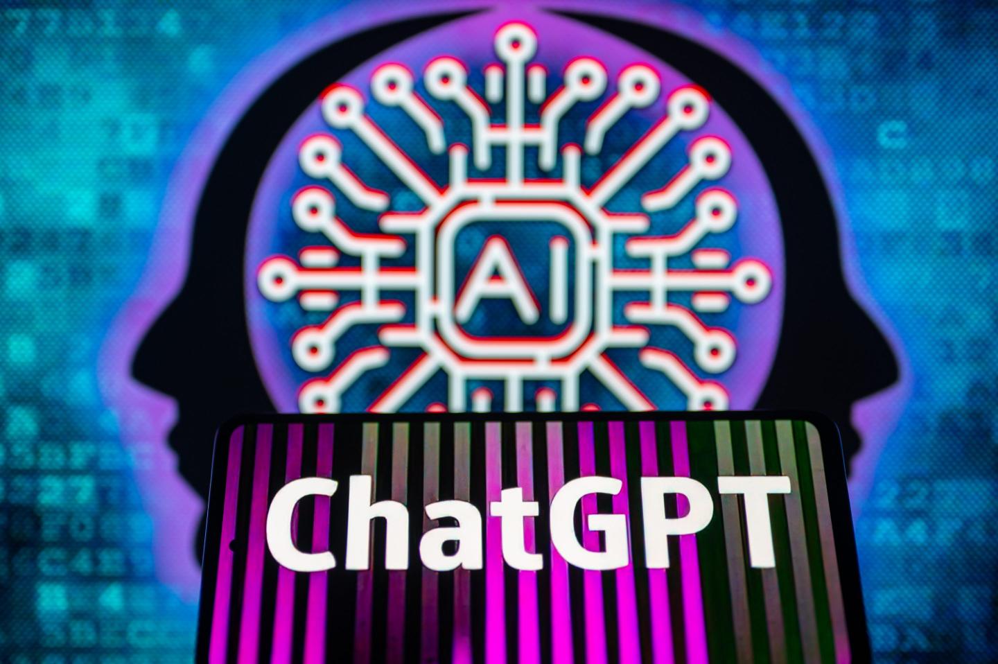 A phone with the ChatGPT logo i front of a screen with a brain illustration.