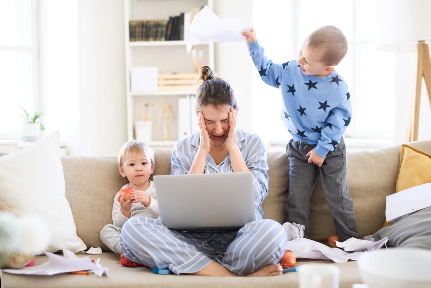 Stressed and frustrated mother with two small children