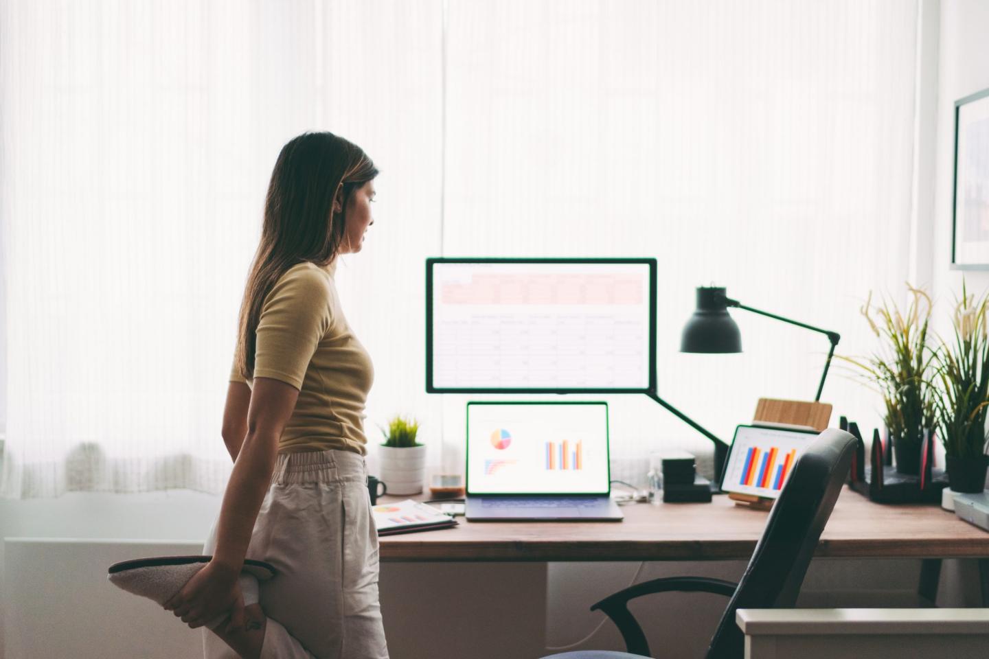 Woman stretching at computer