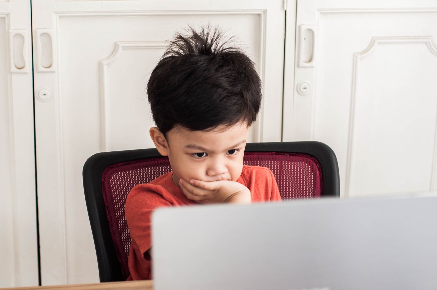 Kid looking at computer