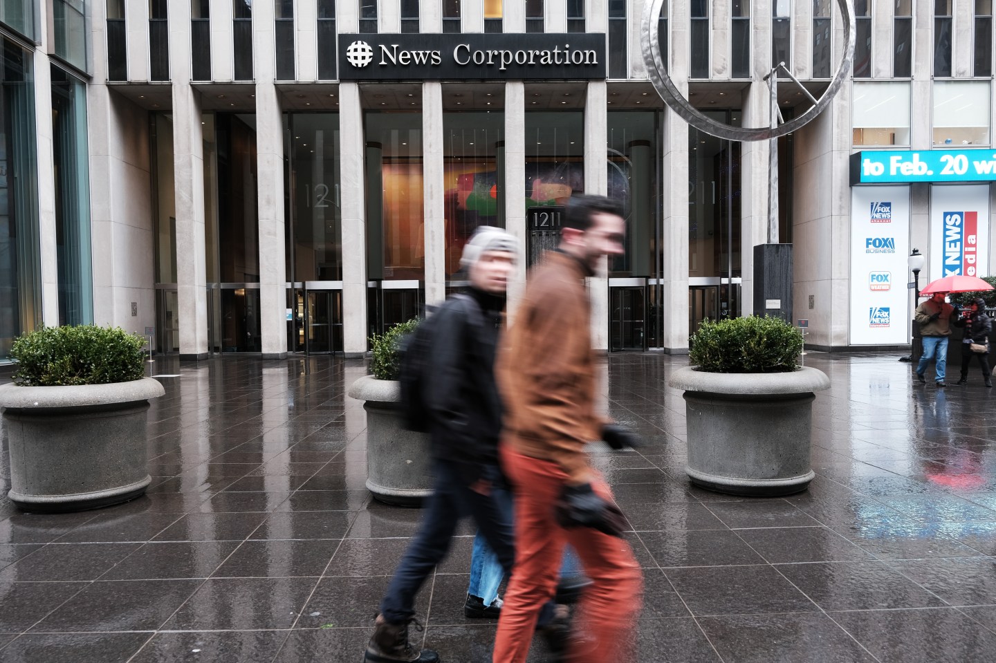 Pedestrians walking past the News Corp. headquarters in New York City