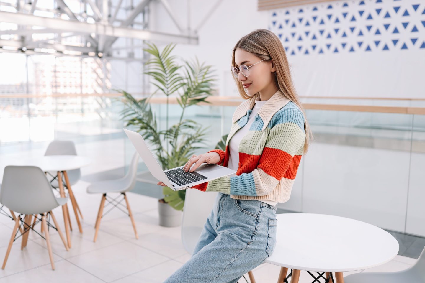 Smiling young worker on a laptop