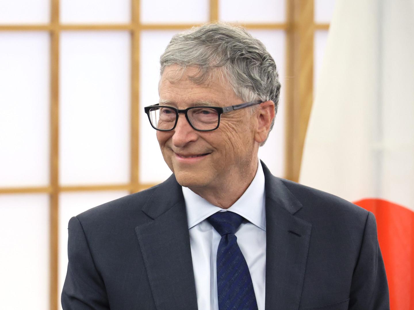 Bill Gates smiling while attending an event in Japan